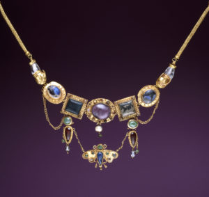  Elaborate diadems or necklaces featuring centerpieces of inlaid stones, pendants, and beaded chains go back to 3rd- and 2nd-century Greek jewelry. This necklace was found on the neck of the deceased; as the symbol of the soul, the butterfly was an appropriate motif for a burial gift.
